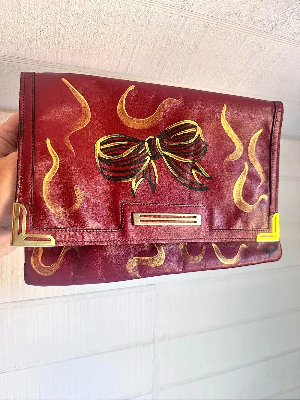 Philippe Embellished hand Painted black Bow Leather Clutch in Red & Gold